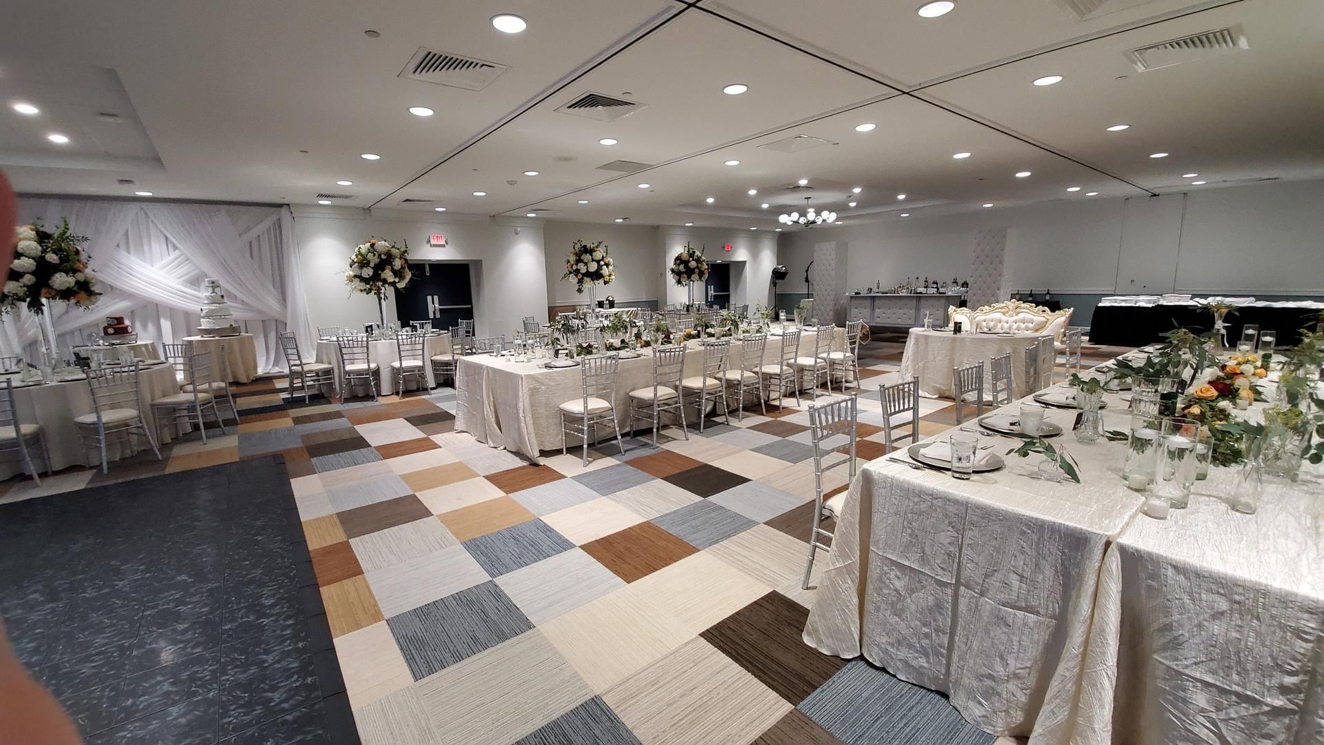 Long wedding table set up in The Barrymore Hotel banquet hall, decorated with soft lighting