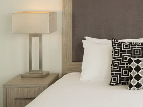 Close up on some pillows and a table lamp at H On Smith Hotel