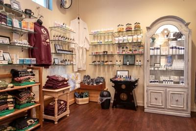 Boutique retail display with skincare products, apparel, and a display cabinet in Moon Spa at La Tourelle Hotel and Spa