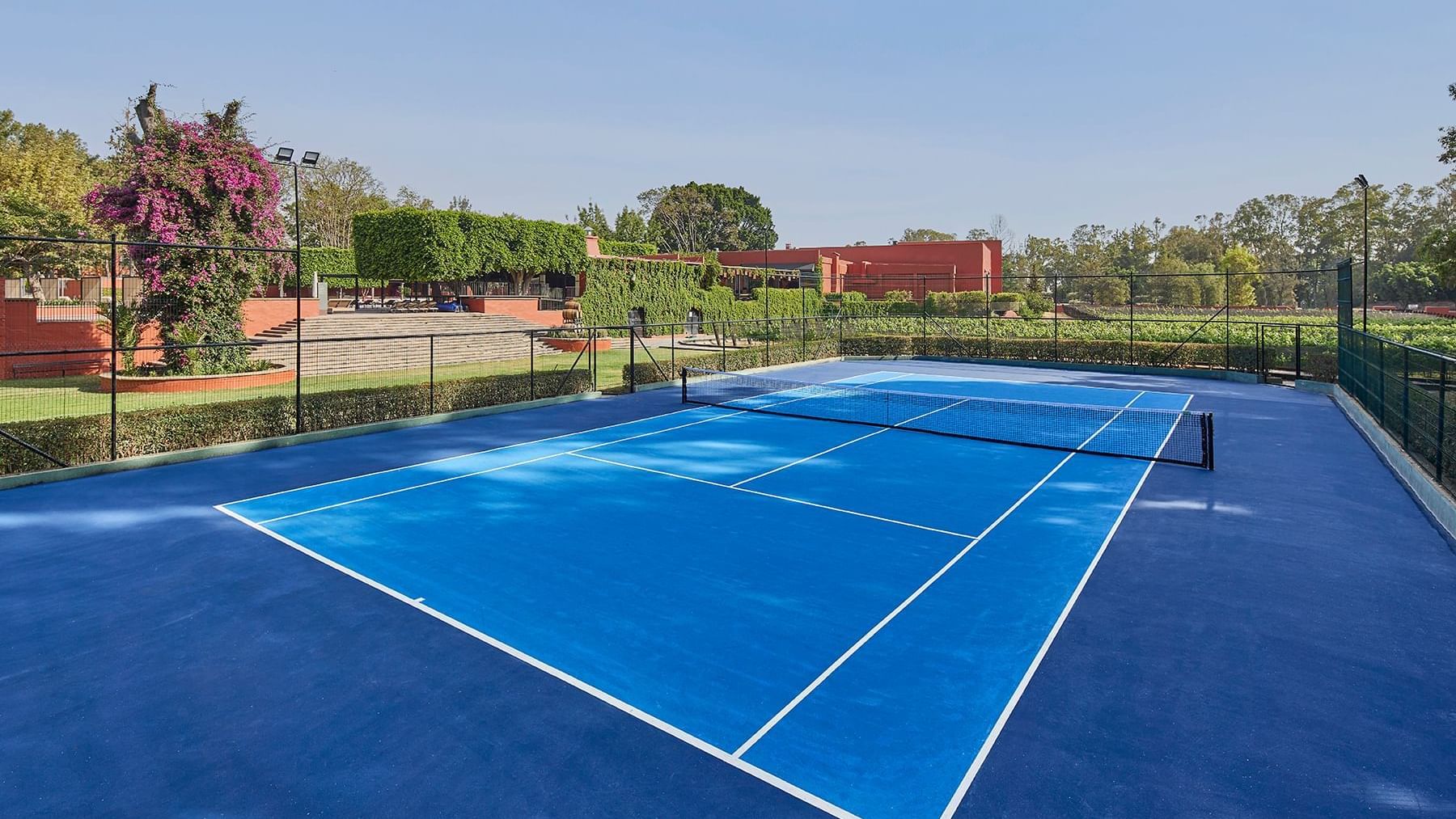 An outdoor tennis court at Fiesta Americana Hacienda