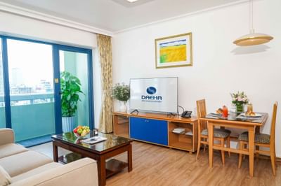 Living room with coffee table, couch, TV at Hanoi Daewoo Hotel