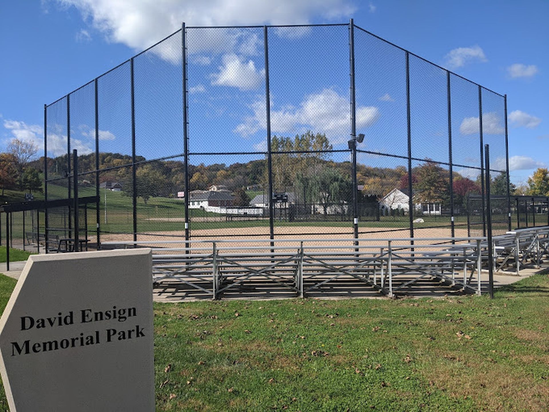Baseball field enclosed by a black fence at David Ensign Memorial Park near Off Shore Resort