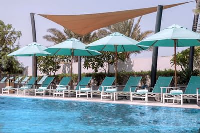 Pool area with pool chairs at Bay La Sun Hotel & Marina