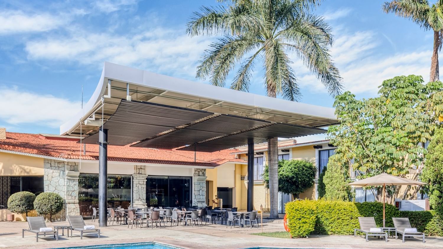 Dining area by the swimming pool at Fiesta Inn