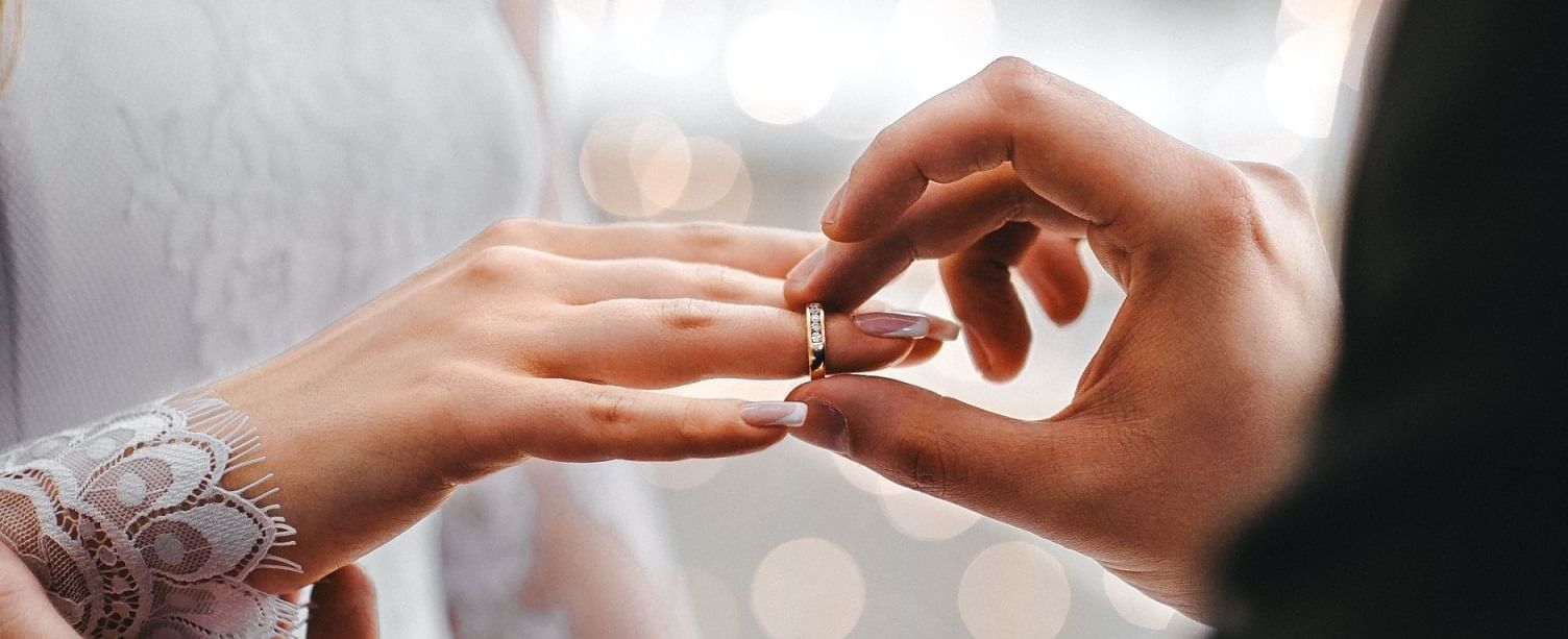 Wedding rings being places on finger