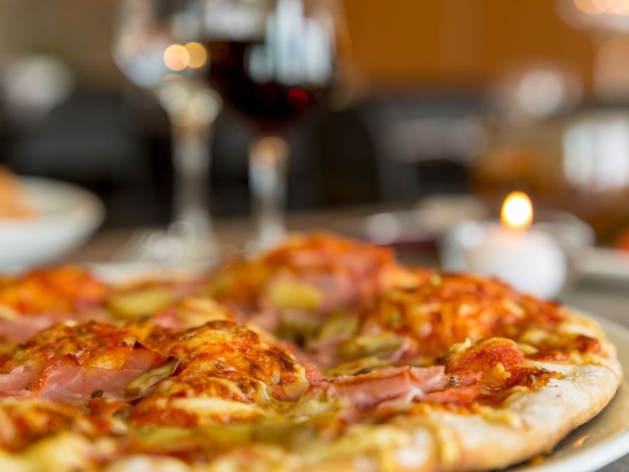 Closeup of a fresh pizza served at Hotel Armony