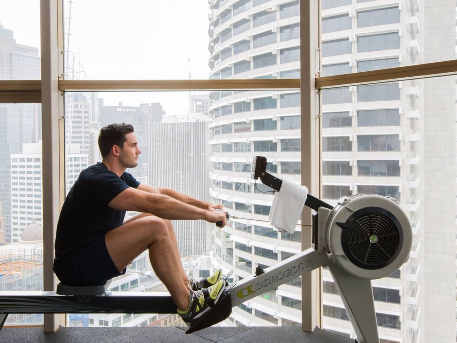 A man using the gym equipment at Sebel Quay West Suites Sydney