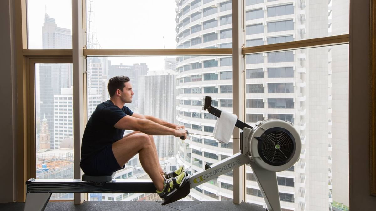A man using the gym equipment at Sebel Quay West Suites Sydney