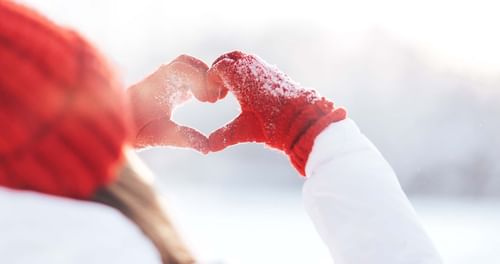 Girl making a heart shape using her hands at Warwick Allerton