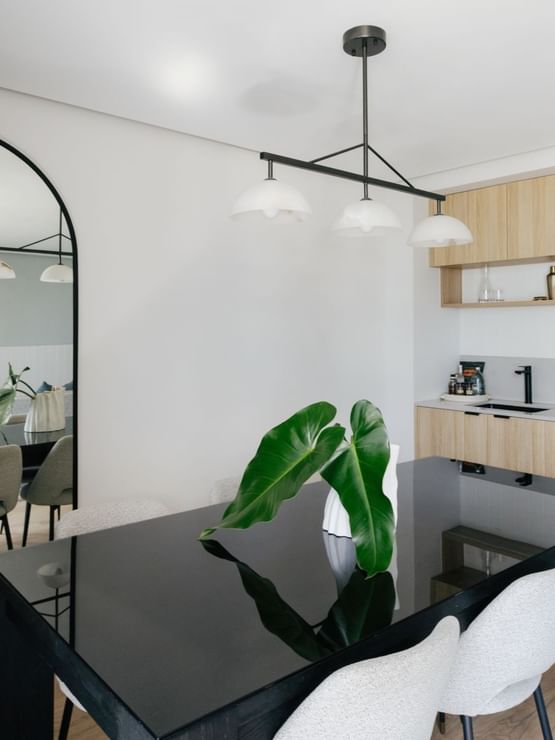 Coastal Two Bedroom Suite at Elysium Manly with a black table under hanging lights, best places to stay in Manly