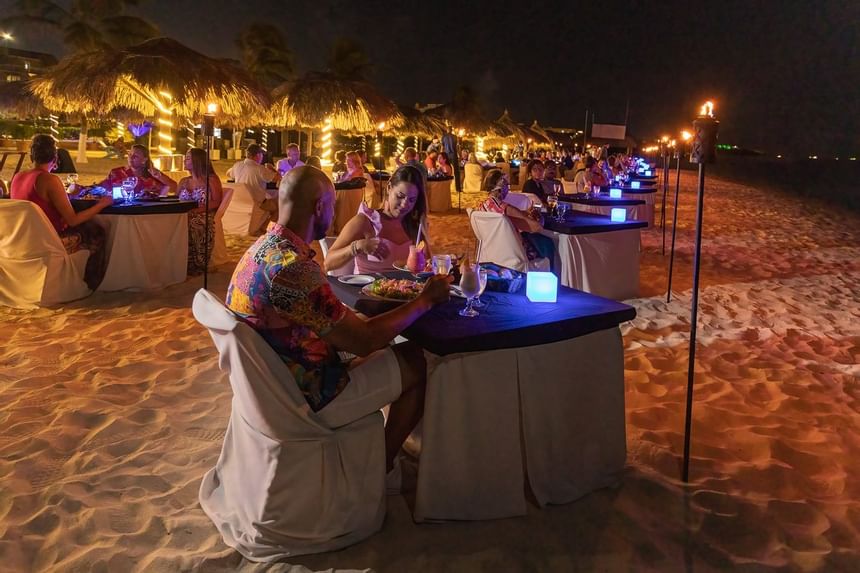 A couple having dinner by the beach at Amsterdam Manor Resort