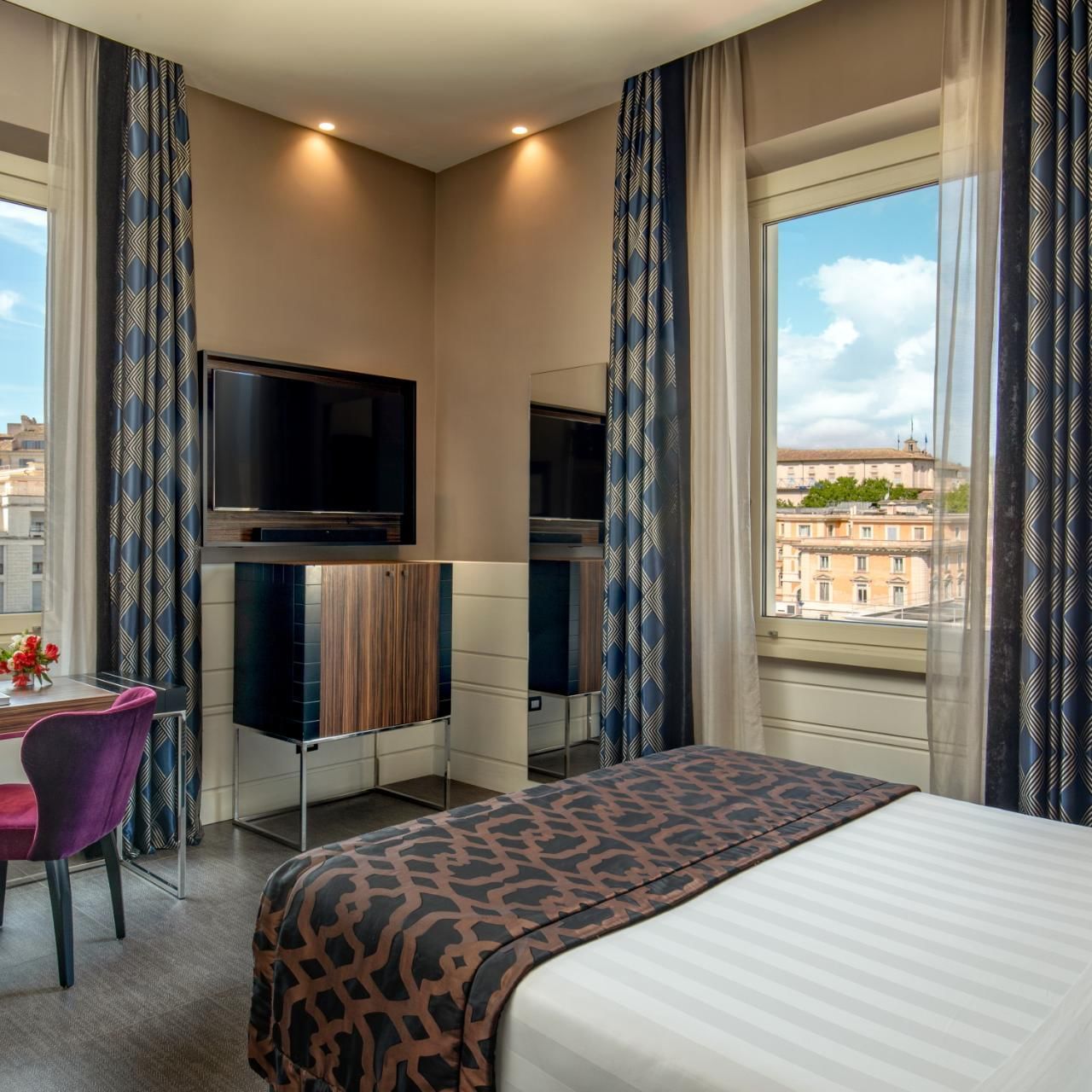 Work desk with TV facing bed by the window in Classic Room at The Glam Hotel