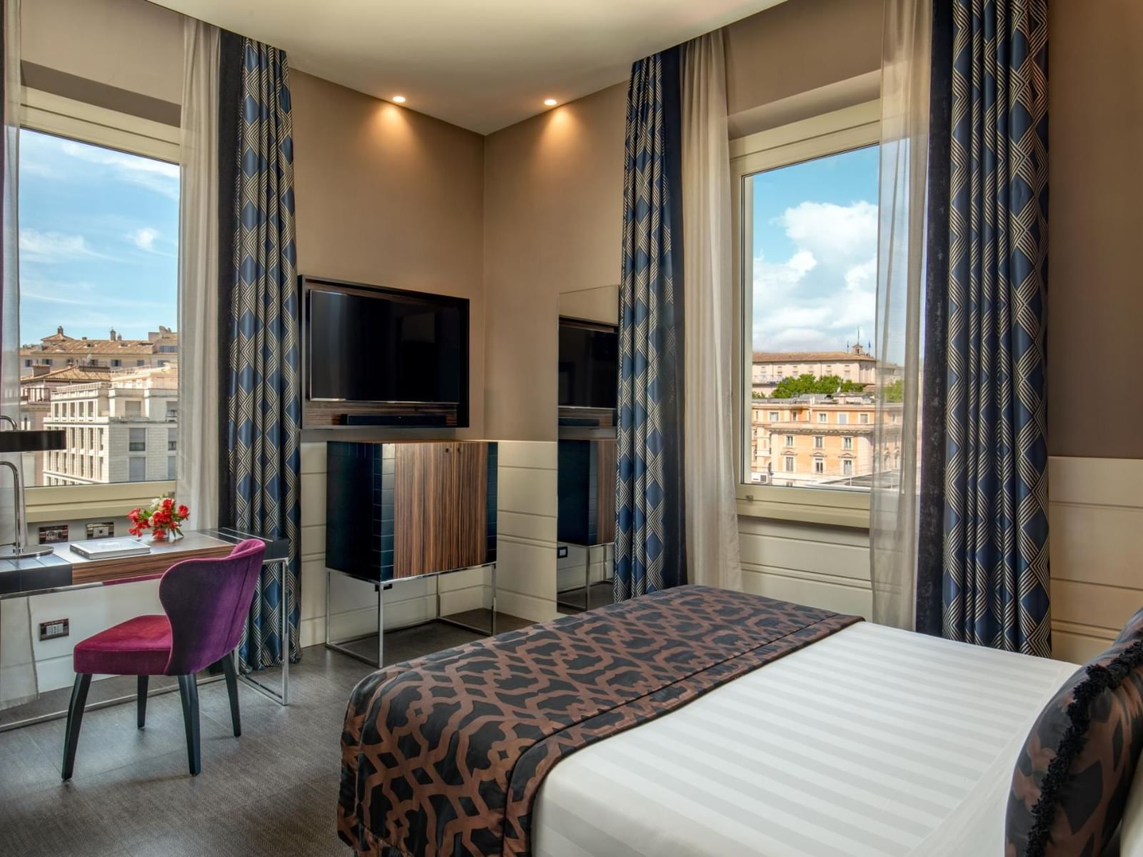 Work desk with TV facing bed by the window in Classic Room at The Glam Hotel