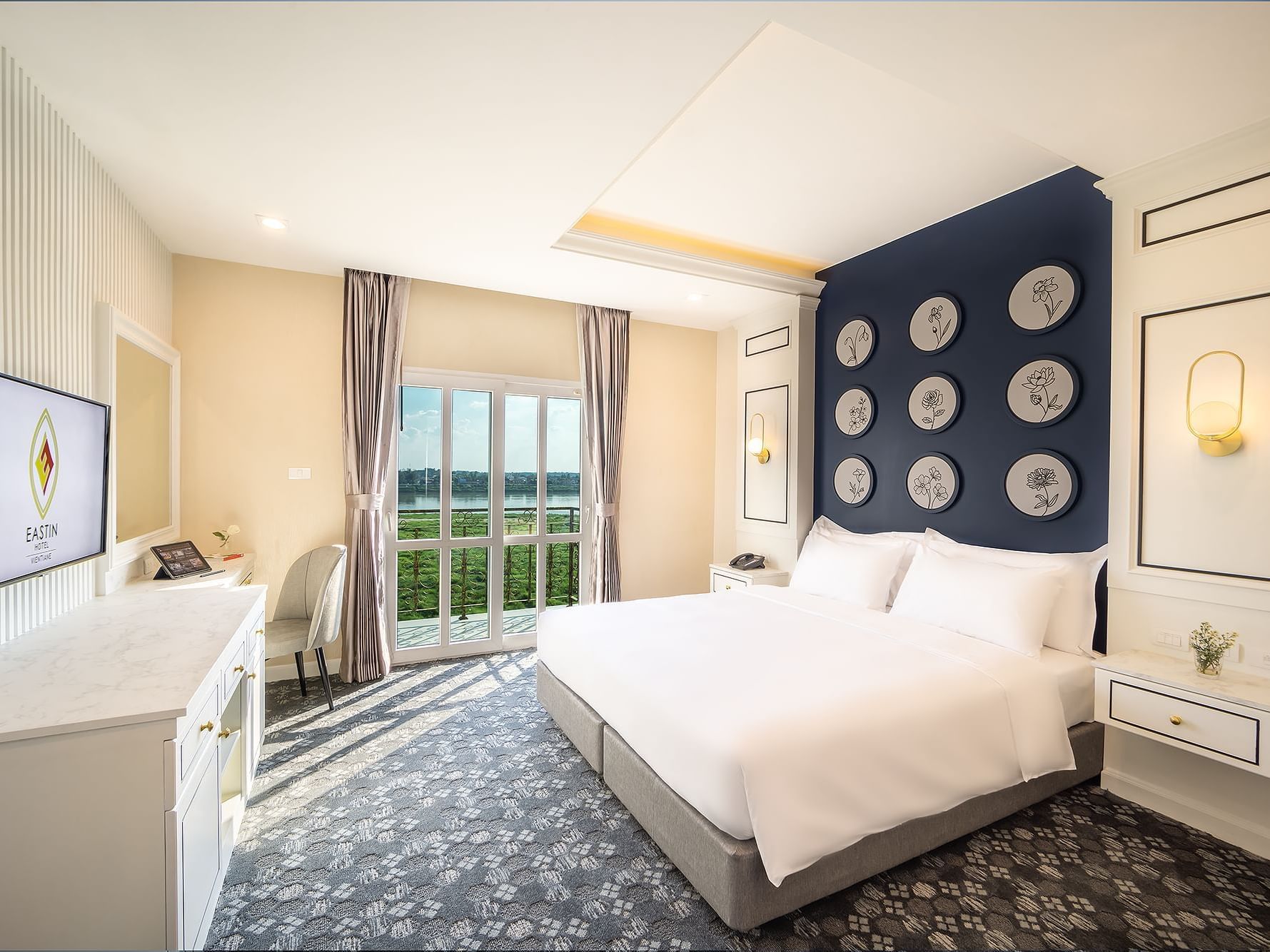 Work desk & TV stand by the king bed in Superior Balcony River View at Eastin Vientiane Laos