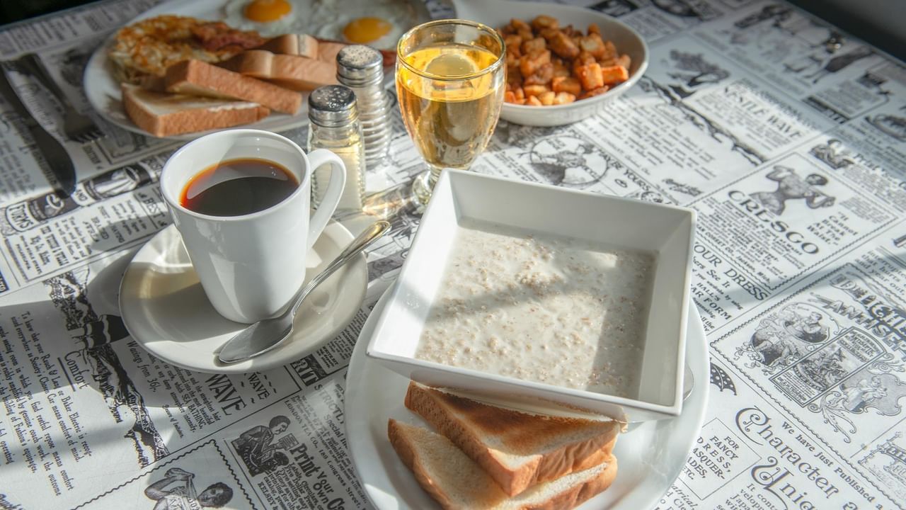 A breakfast spread with coffee, juice, and toast.