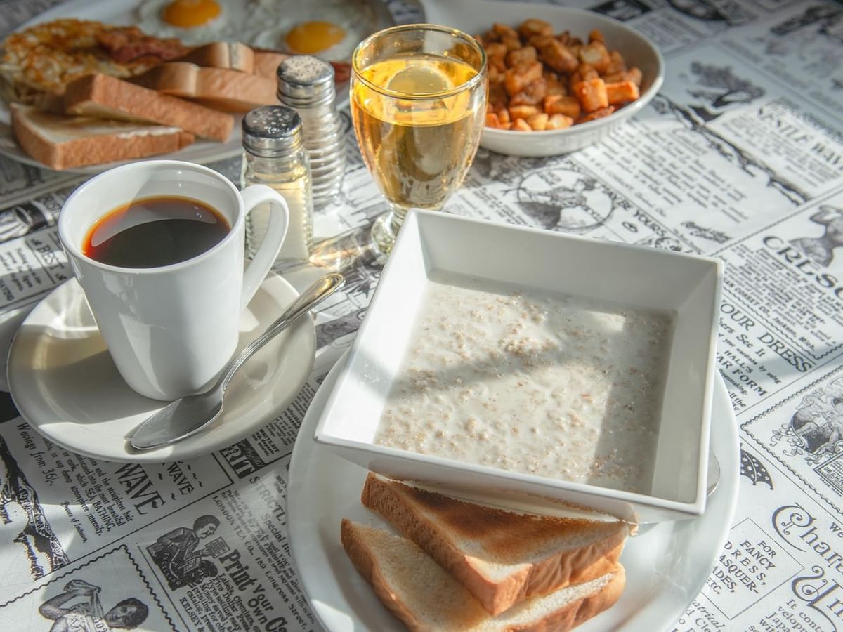 Plates of breakfast food and beverages.