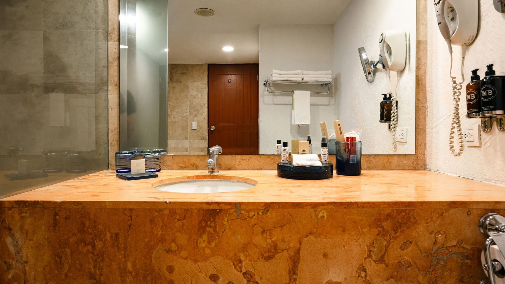 Modern bathroom with large vanity, mirror, and amenities in King Presidential Suite at Camino Real Guadalajara, Zapopan
