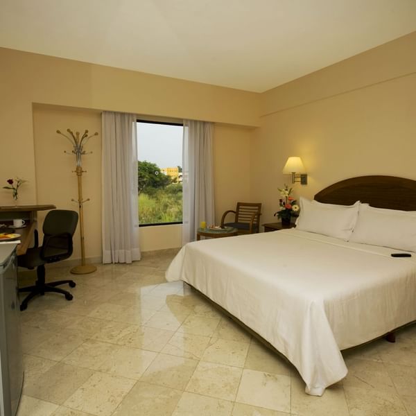King bed with working desk in Superior Room at Fiesta Inn