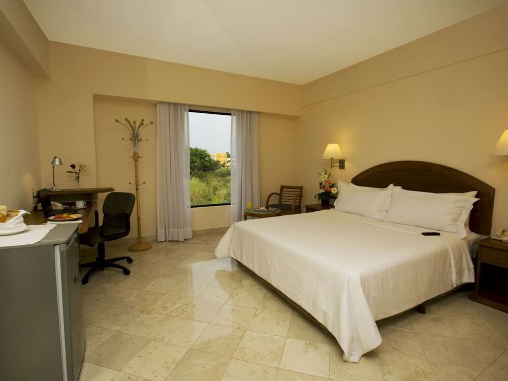 King bed with working desk in Superior Room at Fiesta Inn