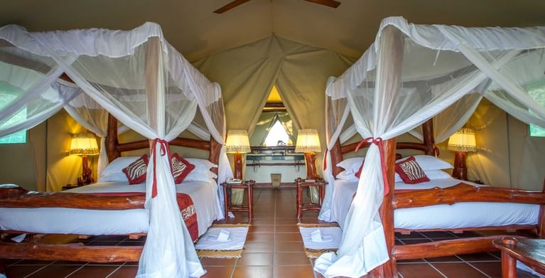 Queen size beds with curtain in Tent at Mbuzi Mawe Serena Camp