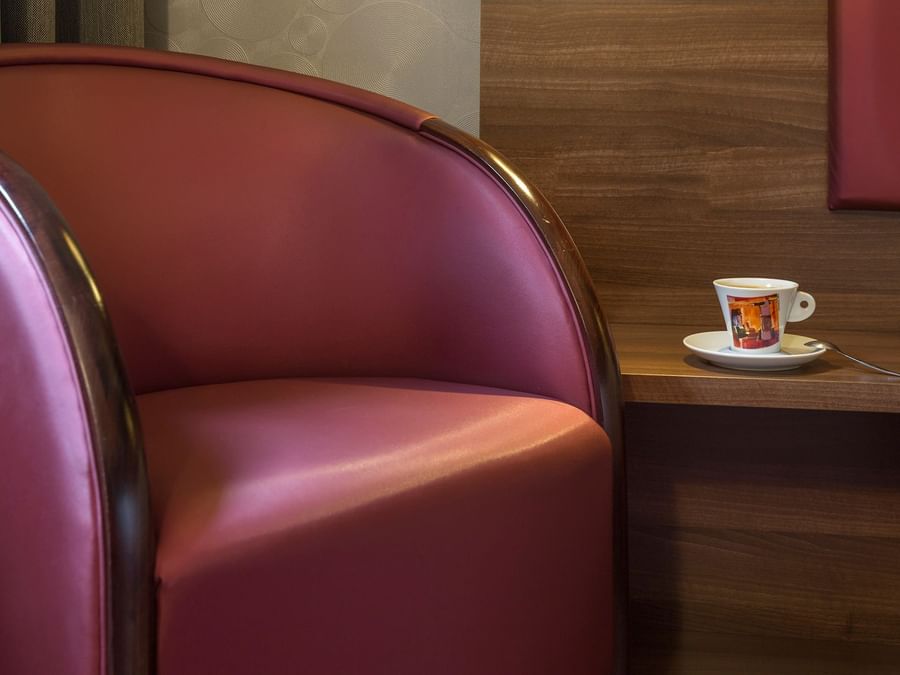 Close up on a chair & a tea cup in a living room at Hotel Aster