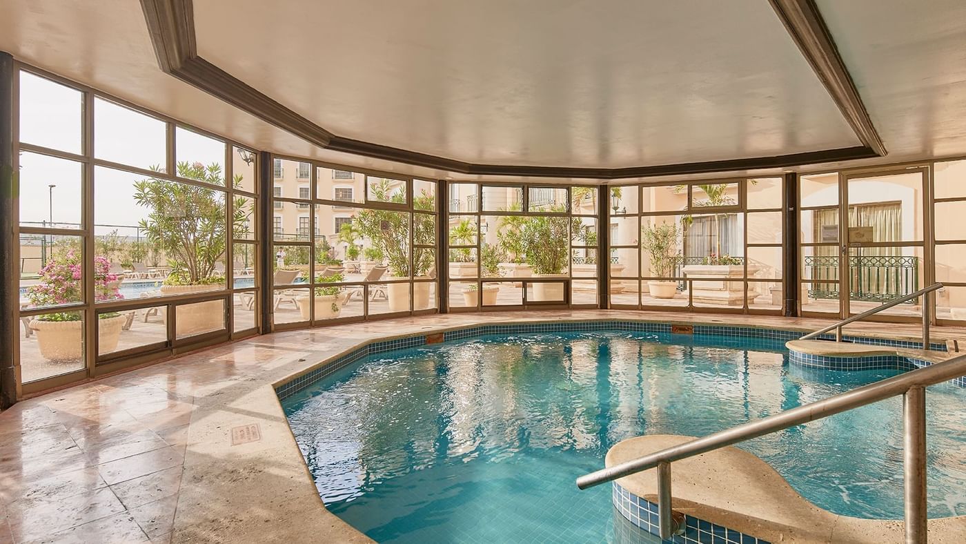 Indoor swimming pool with garden view at FA Hotels & Resorts