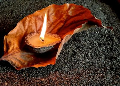 Closeup of a lit candle on a leaf at Punta Islita Hotel