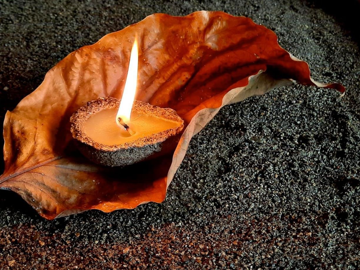 Closeup of a lit candle on a leaf at Punta Islita Hotel