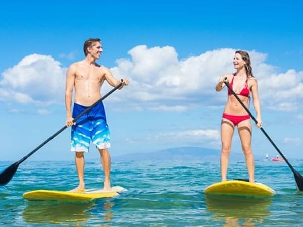 A Couple paddle surfing near Cala Luna Boutique Hotel