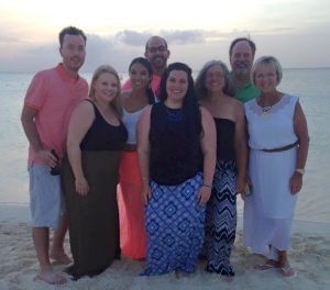 Tourists posing on the beach at The Somerset on Grace Bay