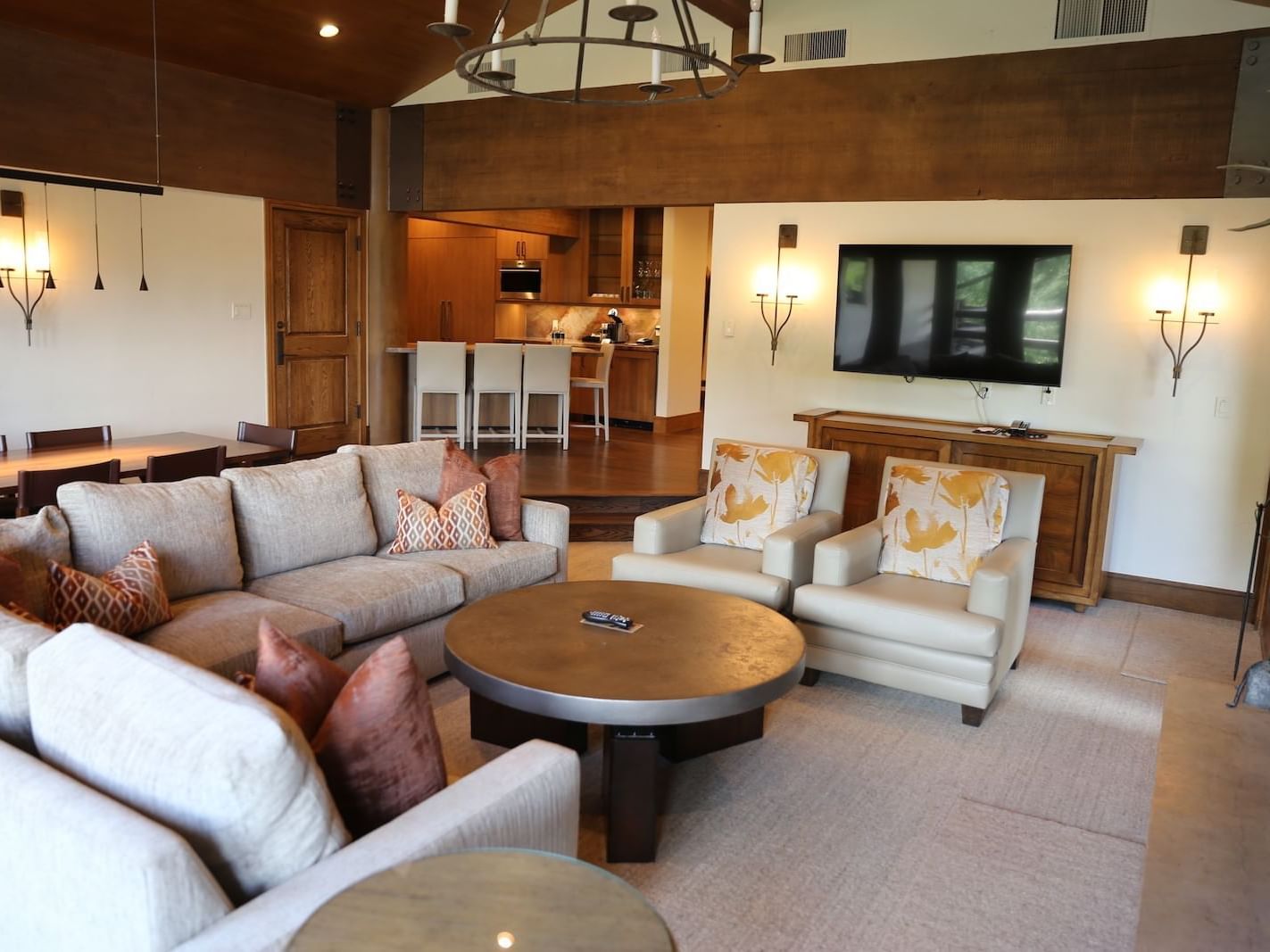 TV lounge area with dining table in Grand Suite at Stein Eriksen Lodge