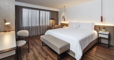 a bed in a hotel room with a desk