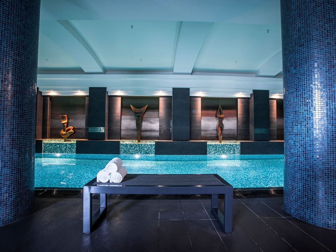 Bench with towels by the magnesium & mineral indoor Spa pool at Quay West Suites Melbourne