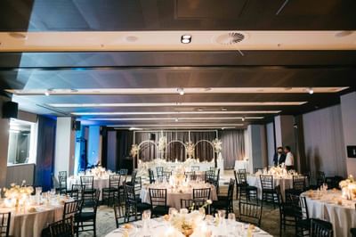 Wedding hall with table arrangements and floral deco at Melbourne Hotel Perth