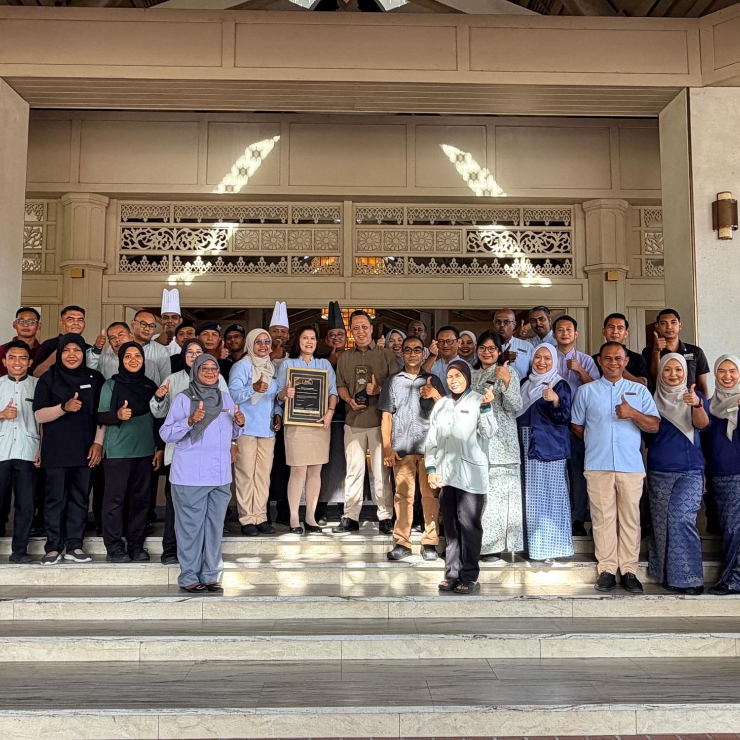 Group photo of staff posing with Leading Island Resort of the Year 2025 award.