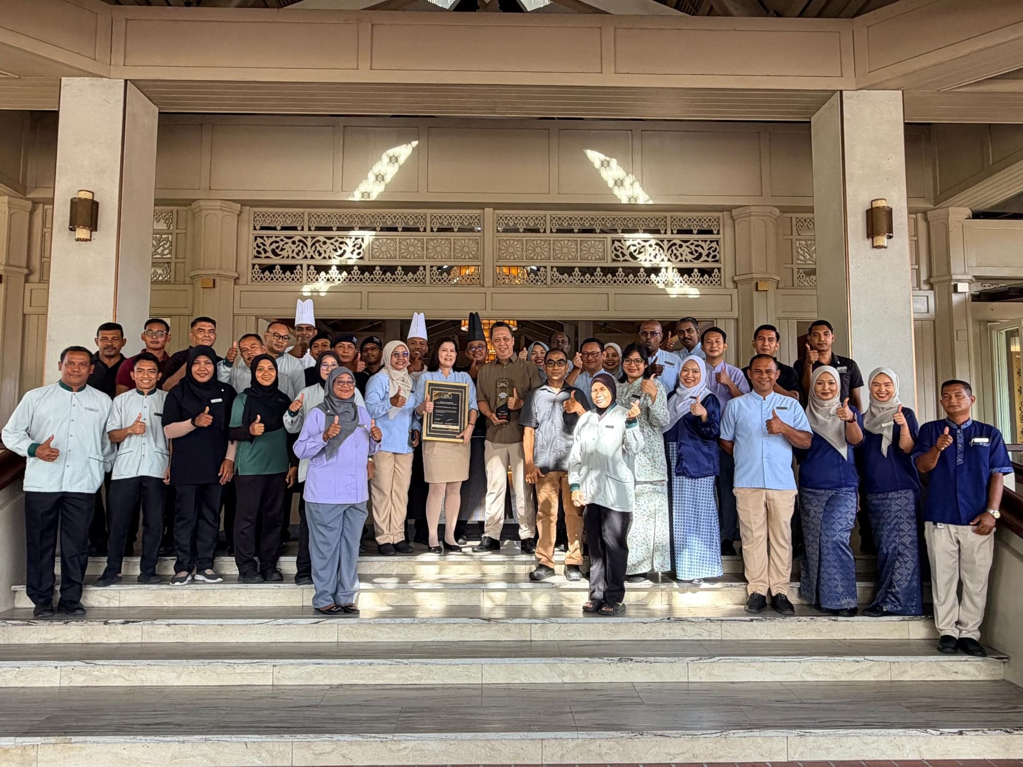 Group photo of staff posing with Leading Island Resort of the Year 2025 award.