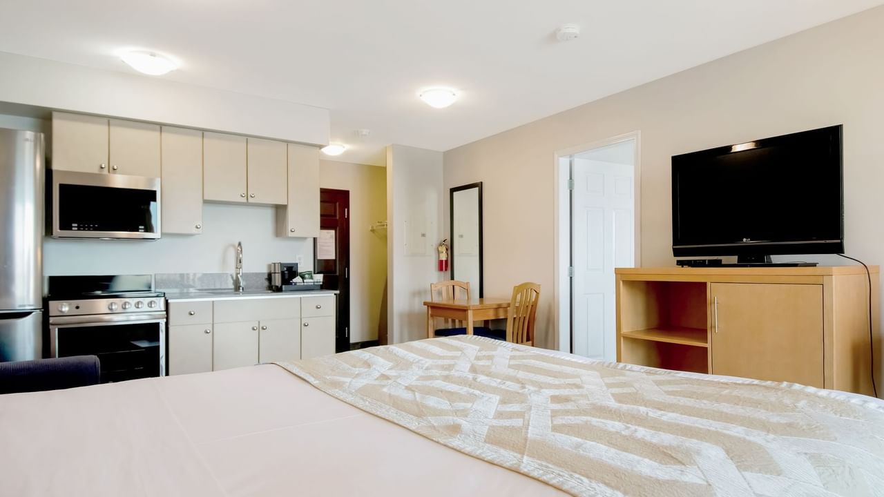 Suite with a kitchenette, dining area, and TV