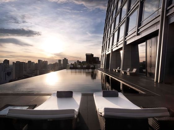 Infinity pool with pool beds at Okura Prestige Bangkok