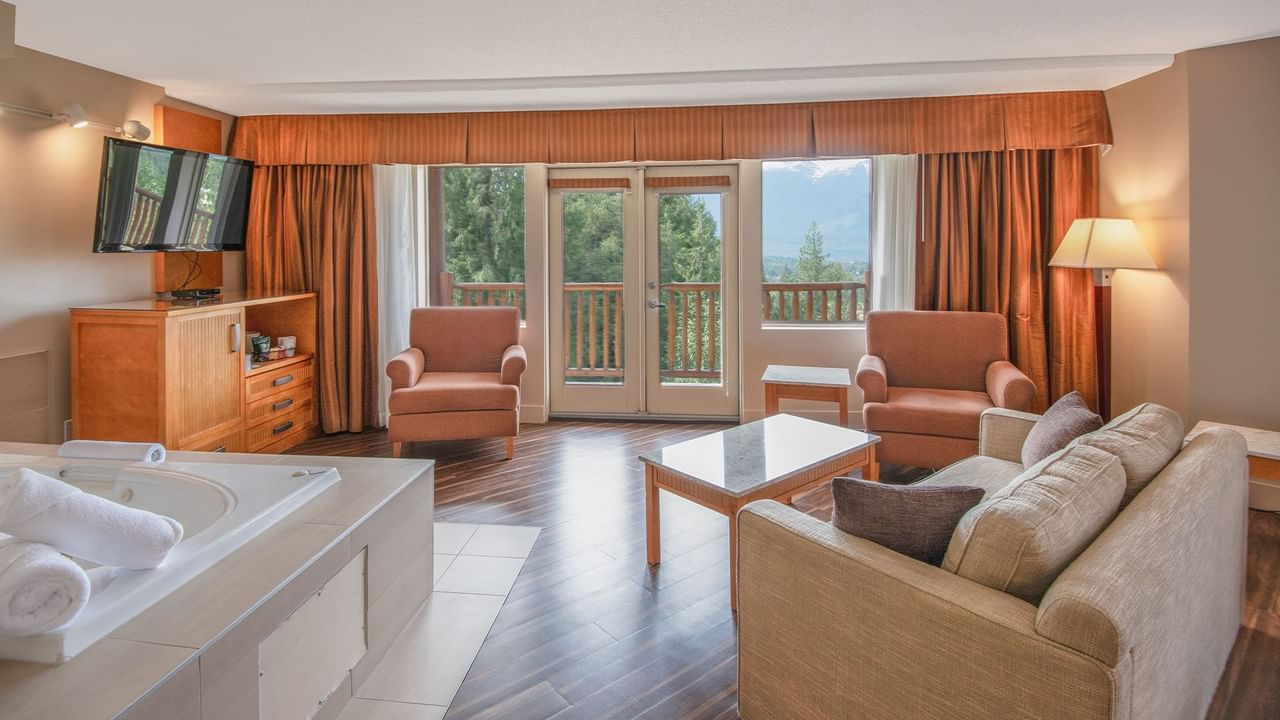 Hotel suite with a king bed and a jetted tub