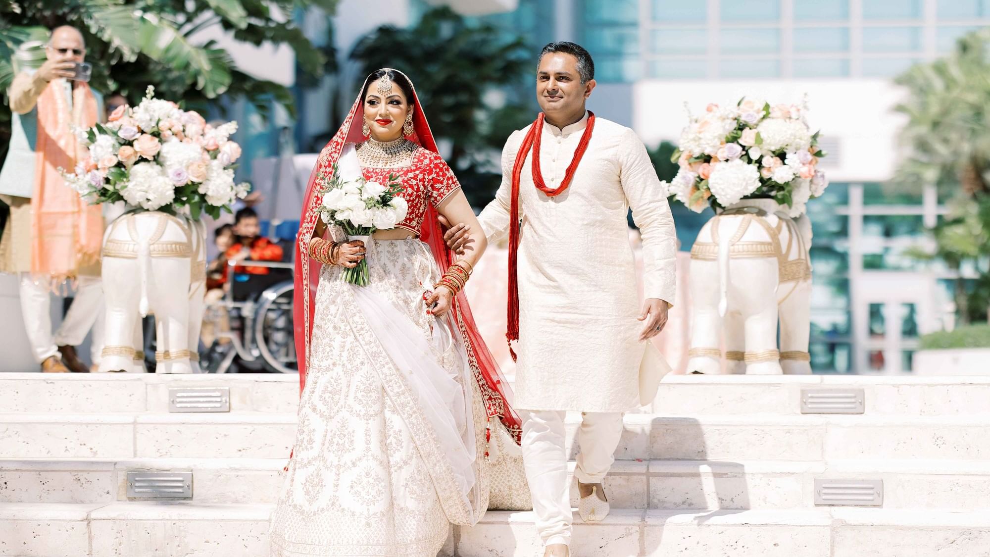 Bride with father transcending down the staircase to the alter at Diplomat Beach Resort