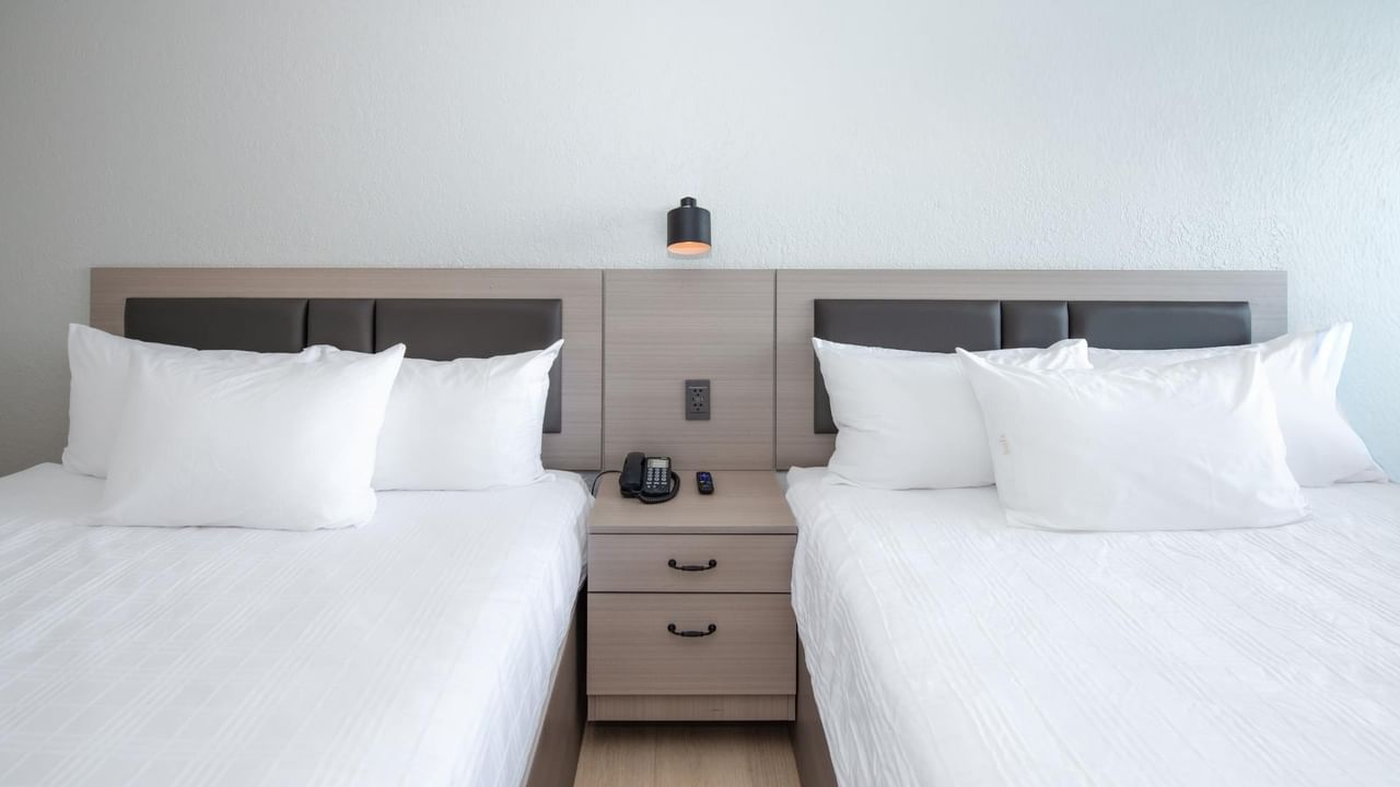 Two queen beds in a guest room at Coast Red Deer Hotel