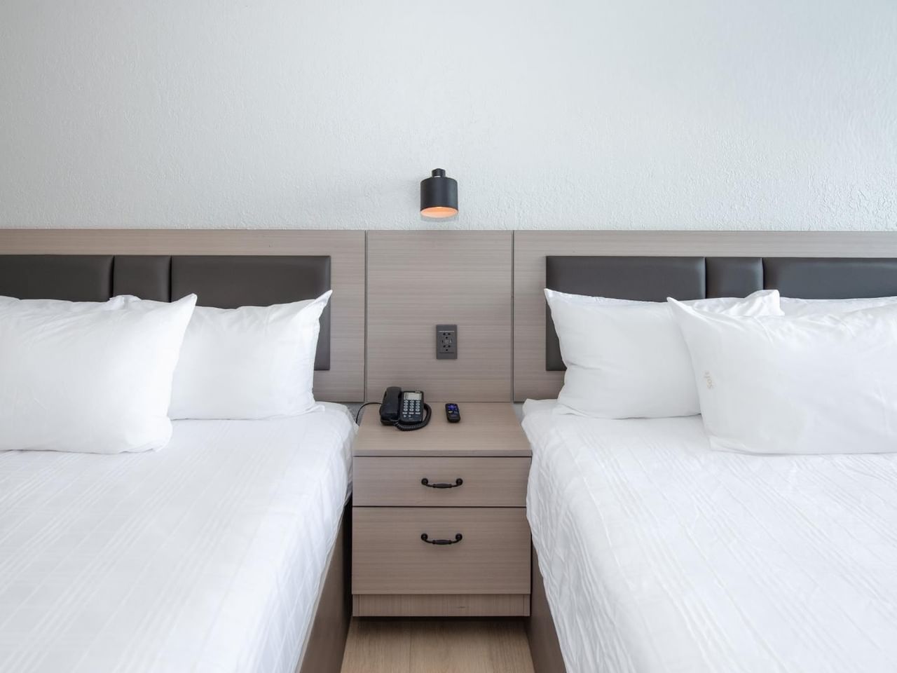 Two queen beds in a guest room at Coast Red Deer Hotel
