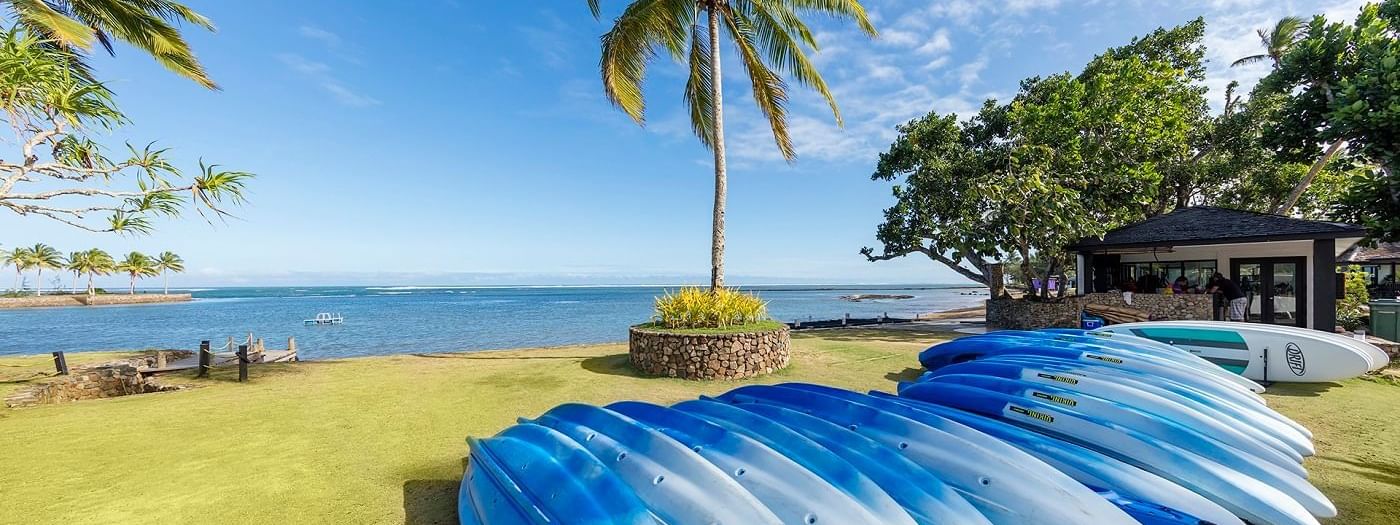 A collection of Kayaks by the ocean at The Naviti Resort - Fiji