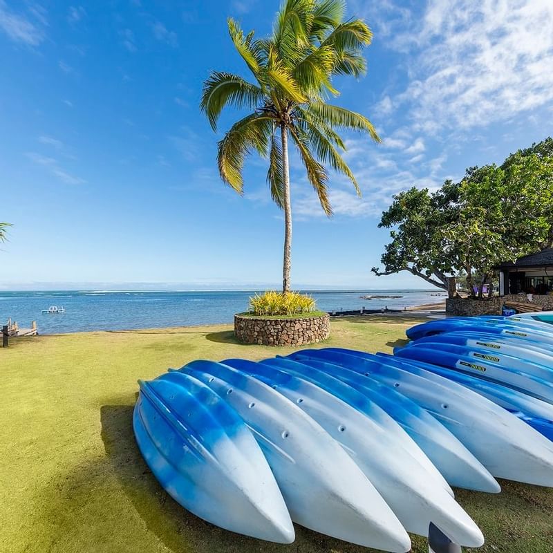 A collection of Kayaks by the ocean at The Naviti Resort - Fiji