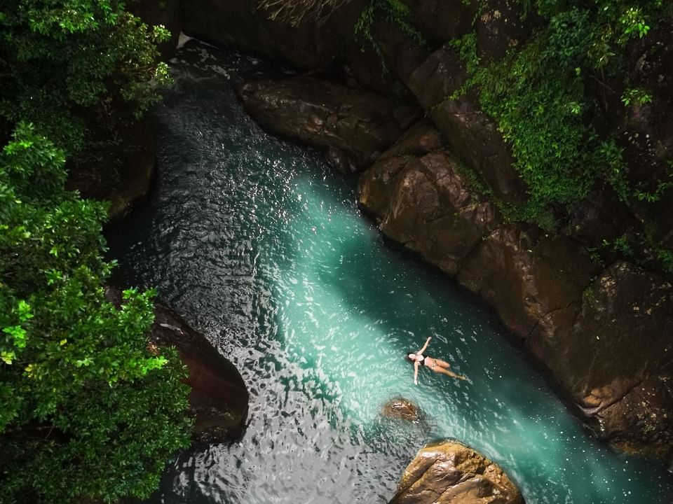 Lady relaxing on the El Yunque National Rainforest river near Las Casitas Village