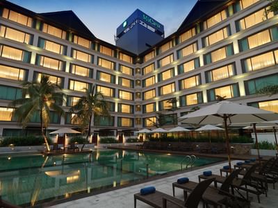 Outdoor swimming pool area with hotel exterior view at MiCasa All Suite Hotel KL