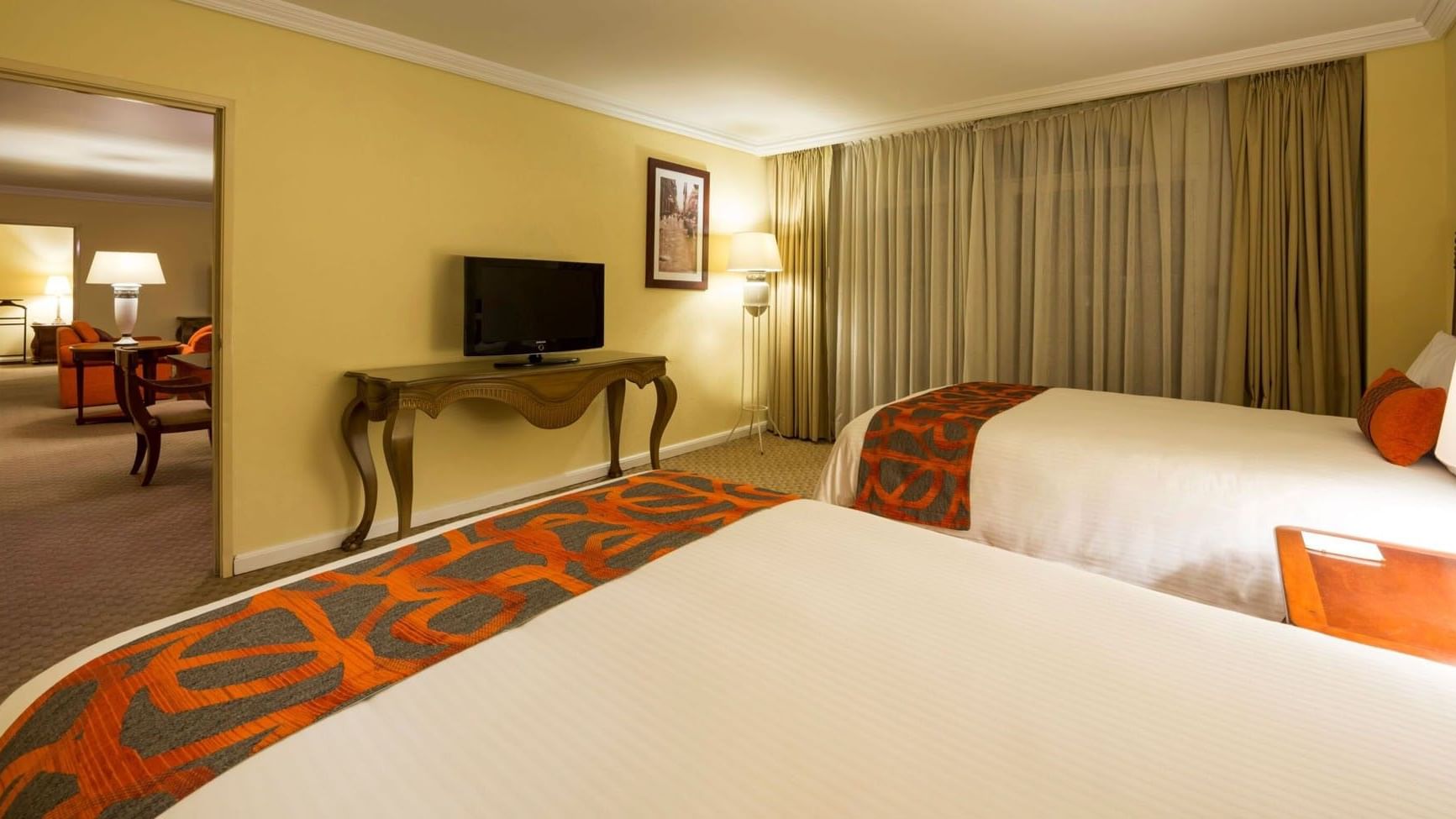 King Presidential Suite with an elegant console table and soft ambient lighting at Camino Real Puebla Angelopolis