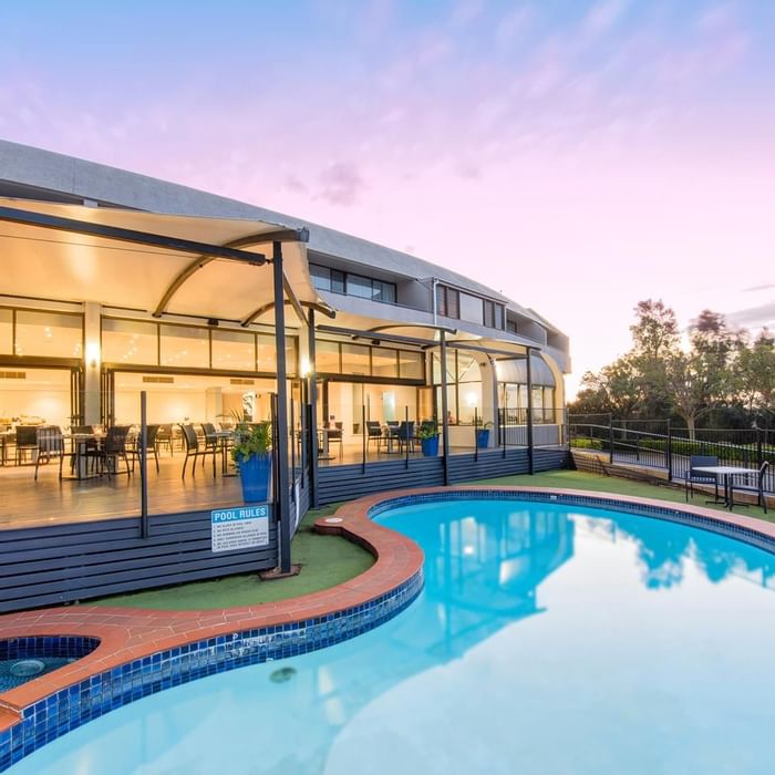 Outdoor pool area beside the dining area with a warm lighting at Mercure Charlestown