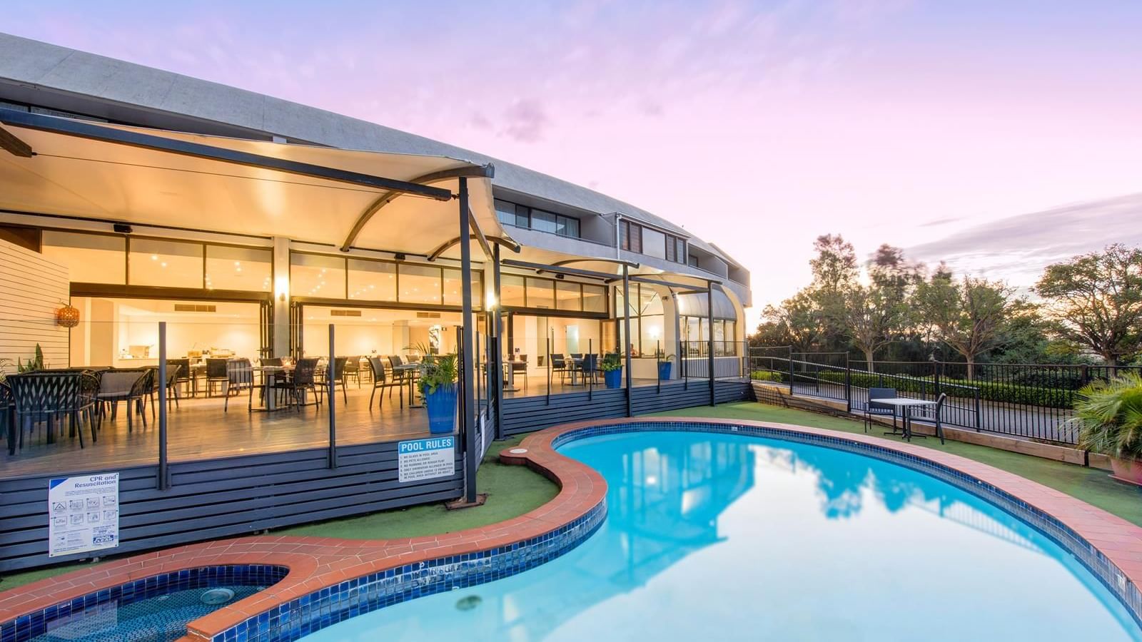 Outdoor pool area beside the dining area with a warm lighting at Mercure Charlestown