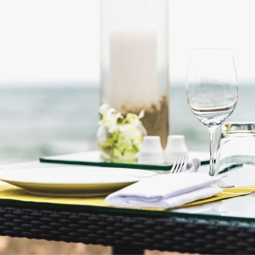 Close-up of a table arrangement with an ocean backdrop near Waikiki Resort Hotel by Sono